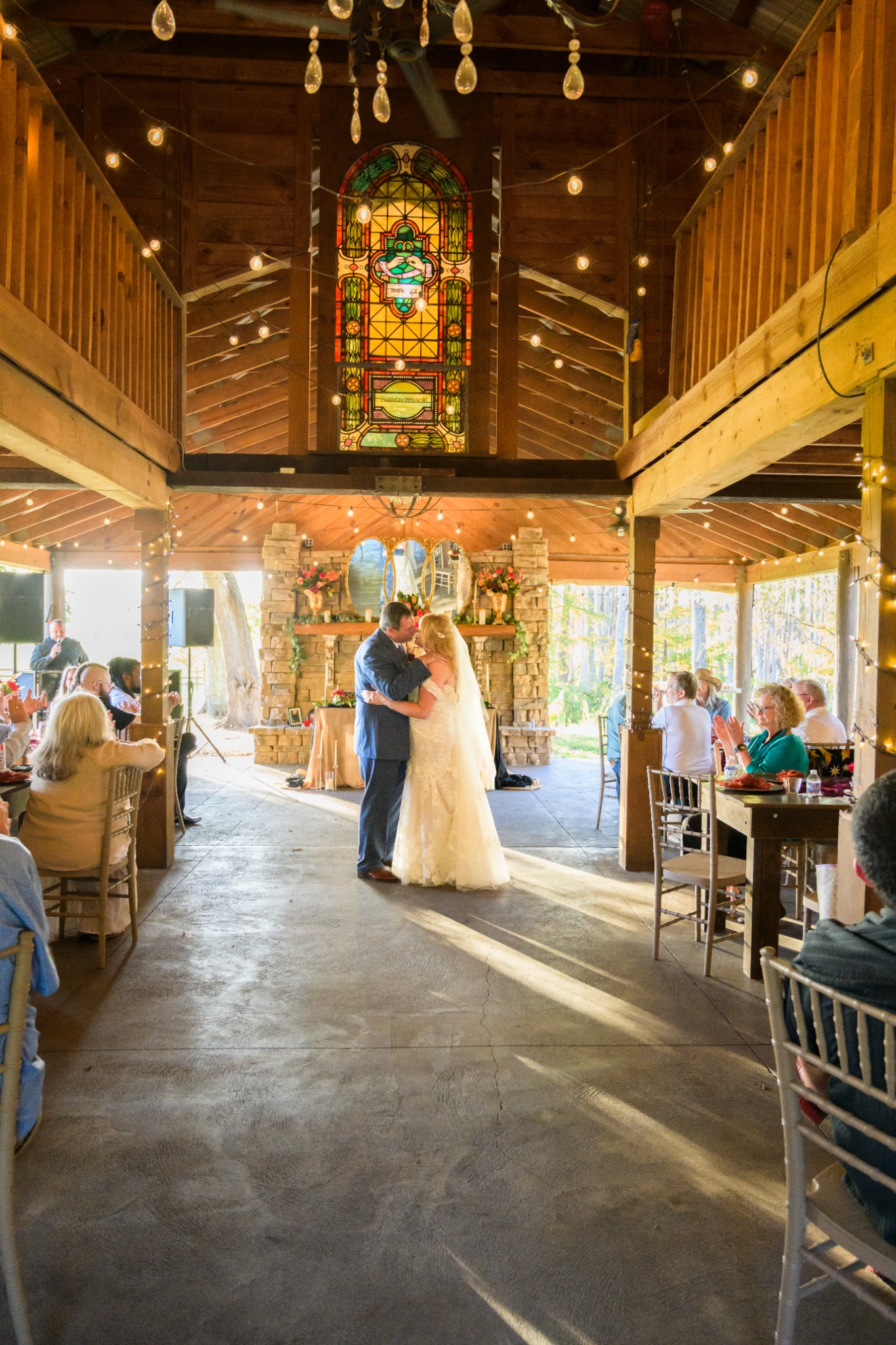 Newlyweds sharing their first dance inside the barn at Wildhorse at Parker Farms