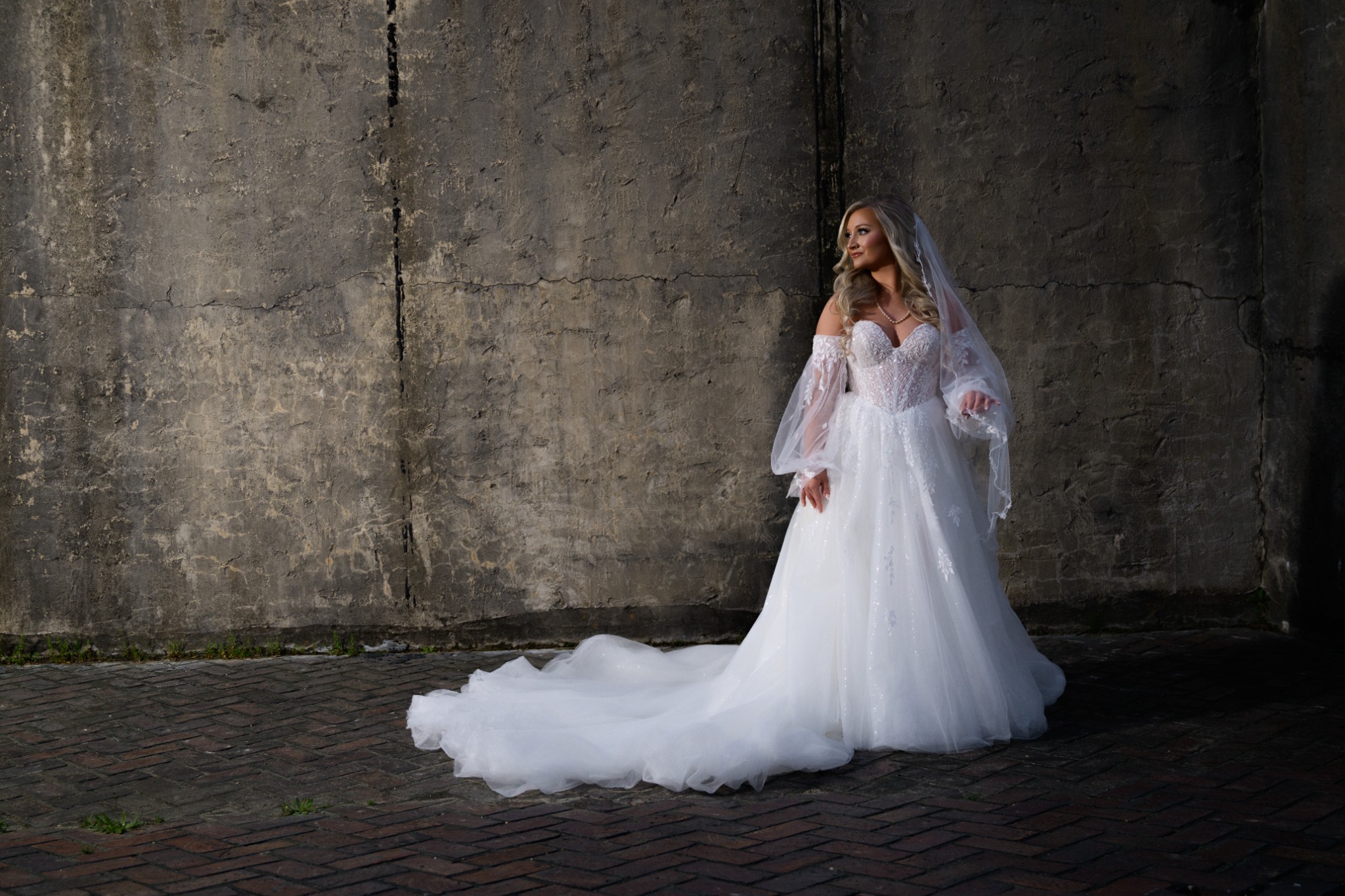 Bride photographed against a weathered wall at Wildhorse at Parker Farms