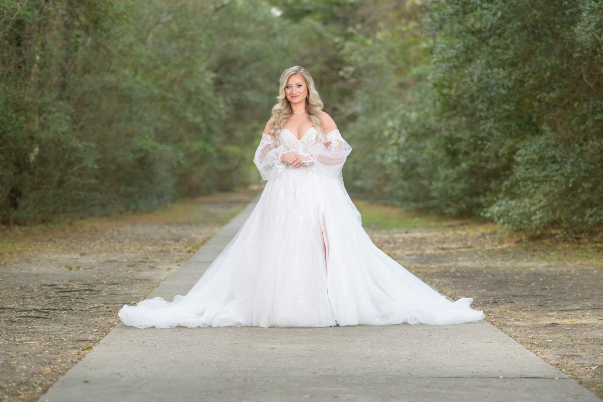 Bride photographed on a wooded path at Wildhorse at Parker Farms